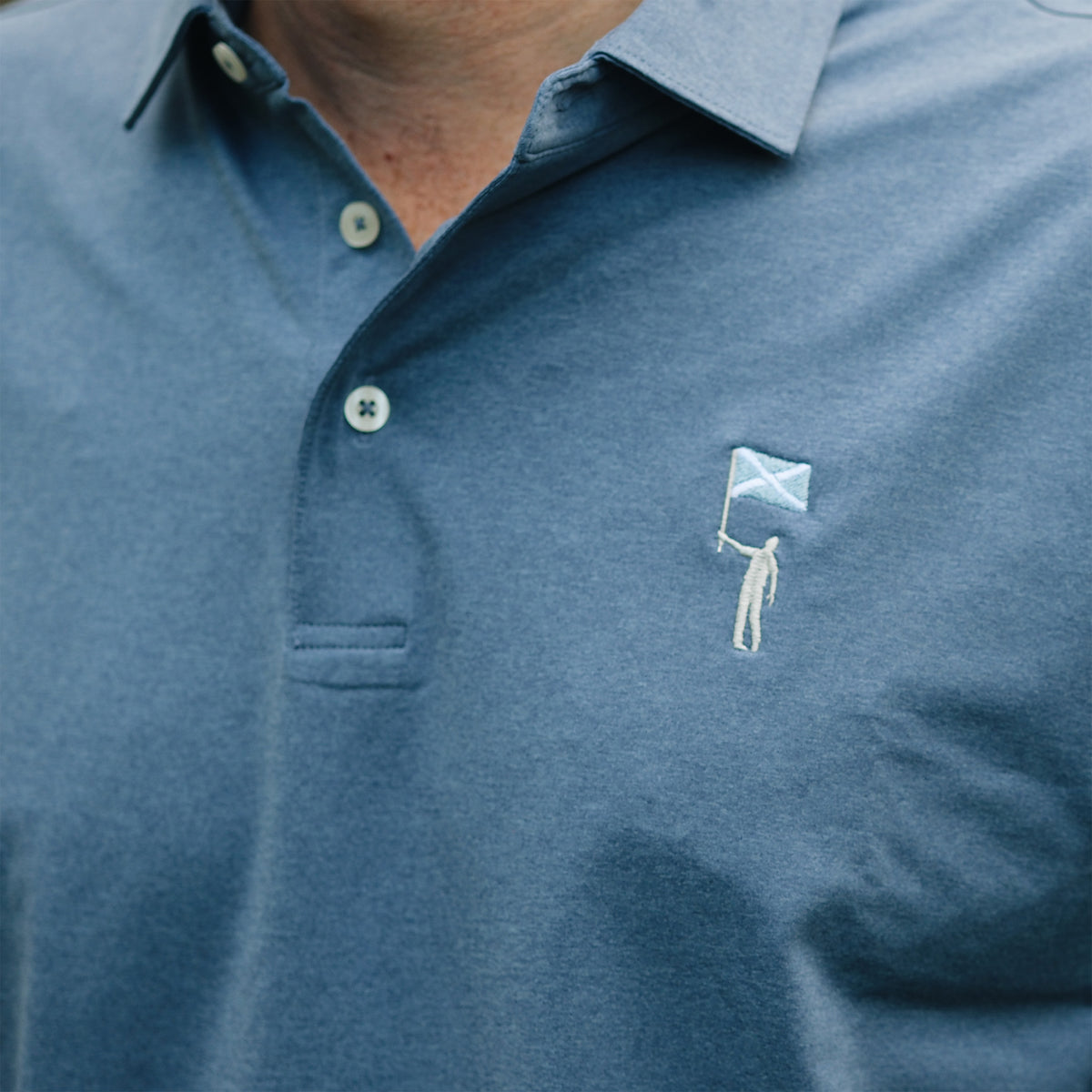 NLU x Rhoback Heathered Performance Polo | Coastal Blue Tourist Sauce Edition
